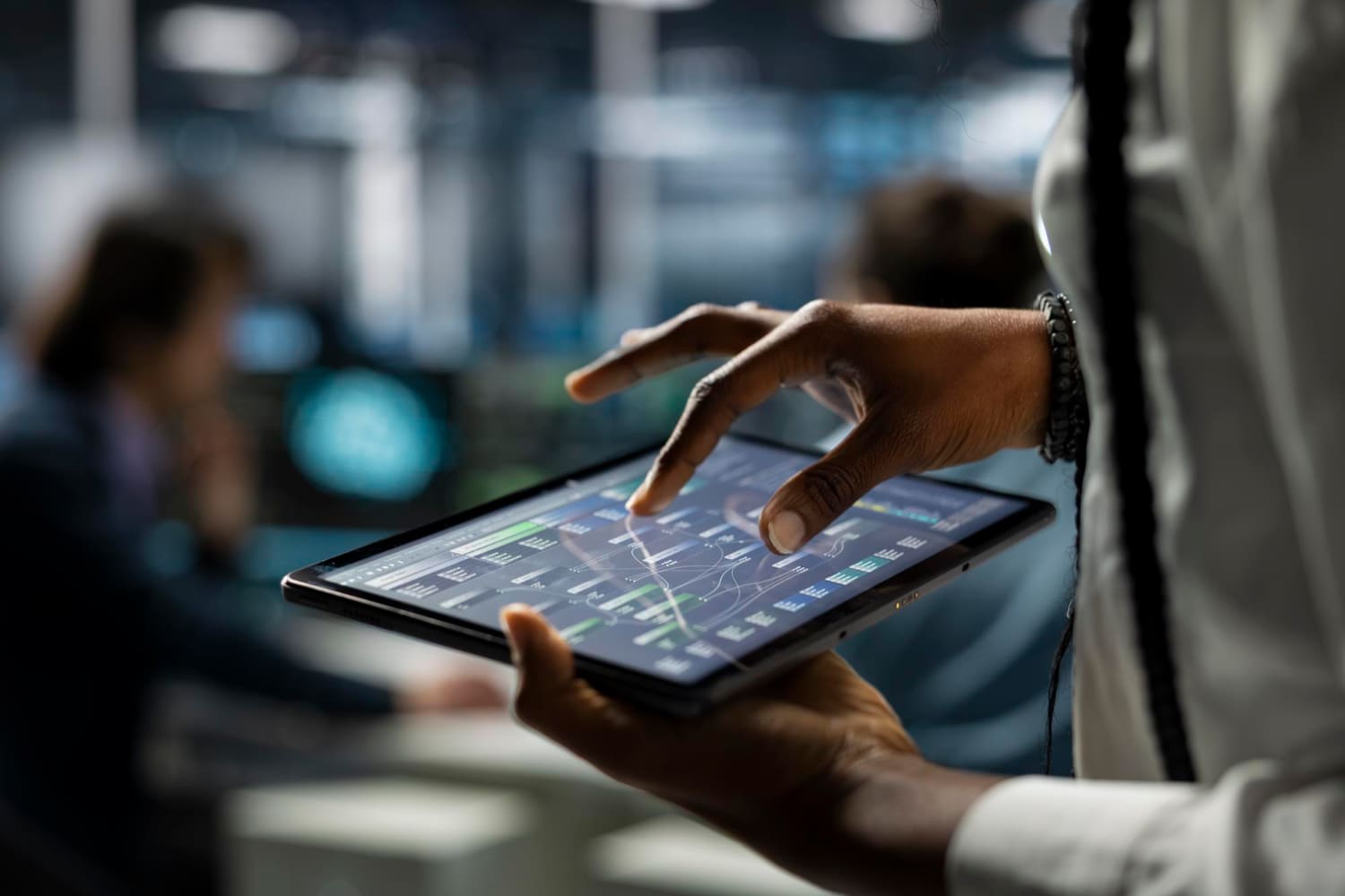 Engineer reviewing monitoring data on a tablet