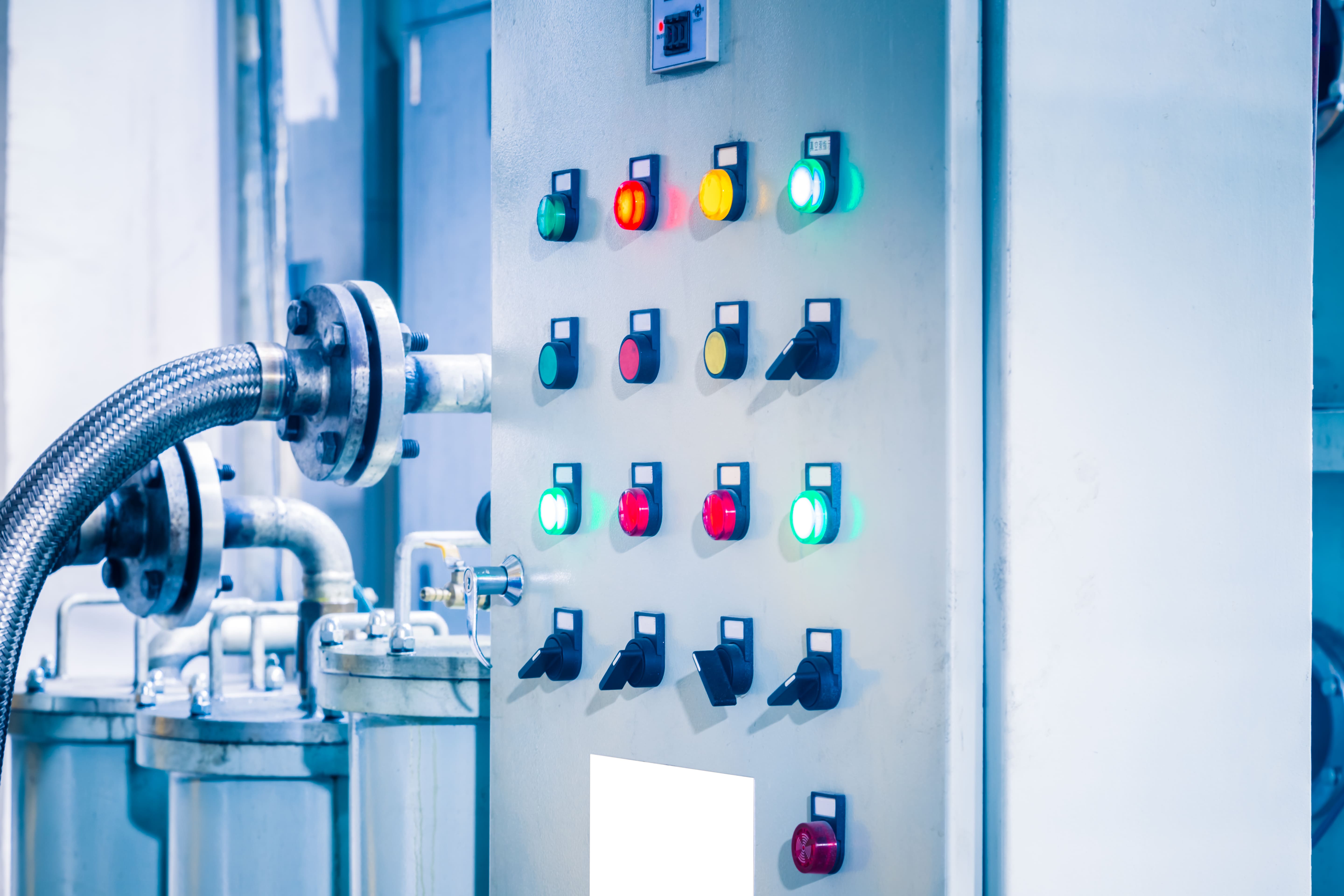 Industrial control panel connected to process pipework